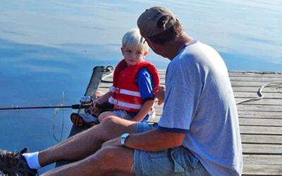 image of Joe Thompson with Collin fishing the dock